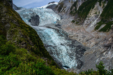 New Zealand tourist popular attractions/destinations concept. Scenic landscape view of valley and Franz Josef Glacier in summer season, located at West Coast, South Island. 