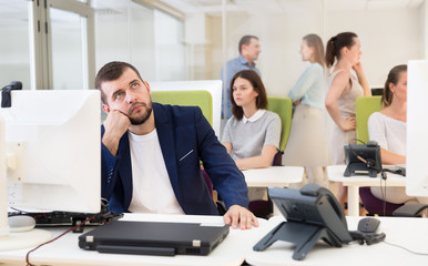 Pensive businessman in coworking space