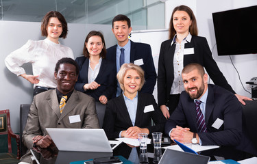 Portrait of happy successful multinational business group in meeting room