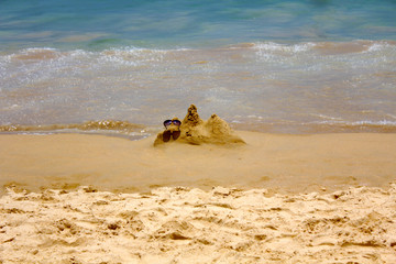 beach and sea. sunglasses on the sand