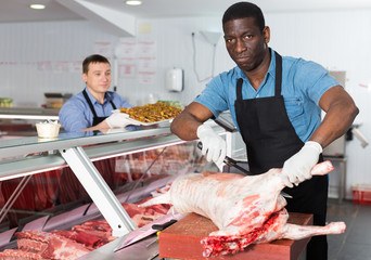 Seller preparing meat of lamb