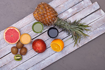 whole pineapple and citrus fruits, top view