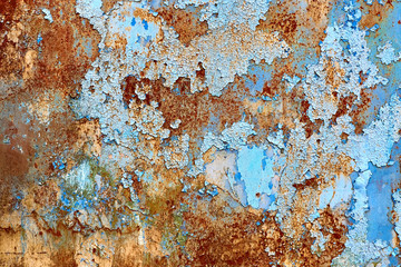 Rusted painted background. Peeled blue paint on metal wall. 