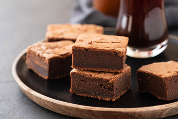 Double Chocolate Brownies. Homemade chocolate fudge brownies with chocolate chips and black background. Copy space.
