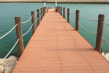 wooden port with rope on water 