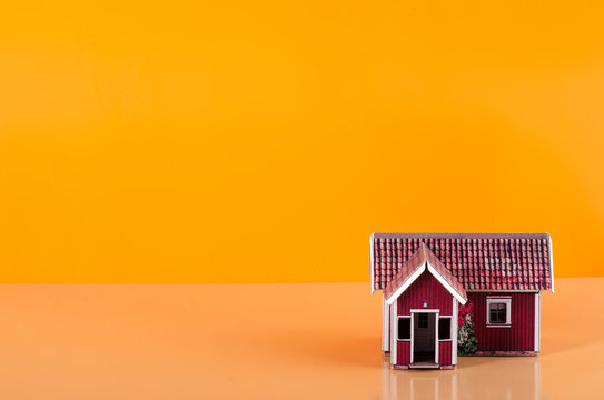 Small house miniature business on orange background
