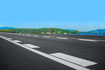Empty asphalt road and natural landscape under the blue sky