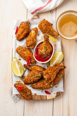 Chicken nuggets with sauce and pepper on a white board. Copy space.