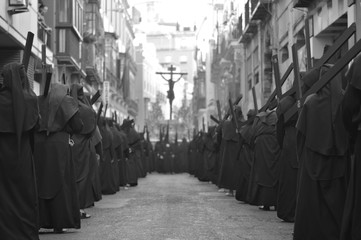Jesus Christ on the cross guides the procession of the penitents