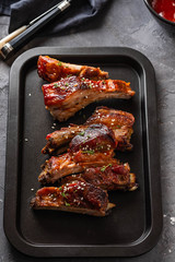 Delicious barbecued ribs seasoned with a spicy basting sauce. lose-up, copy space.