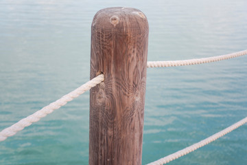 wooden column and rope with water 