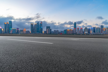 Obraz premium Empty asphalt road along modern commercial buildings in China,s cities