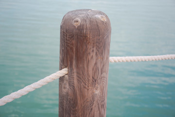 wooden column and rope with water 