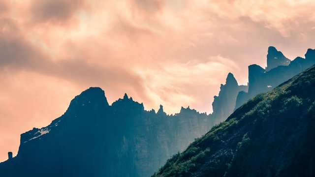Dramatic clouds moving behind mountains cinemagraph