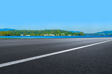 Fototapeta premium Empty asphalt road and natural landscape under the blue sky
