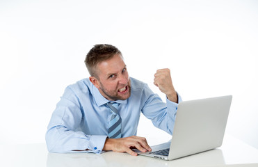 Businessman overwhelmed and desperate at work angry yelling at laptop computer