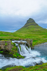 Kirkjufell mountain , and the Kirkjufellsfoss waterfalls