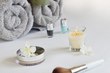 spa setting with towel ,candle and products