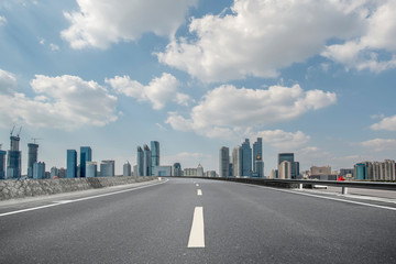 Empty asphalt road along modern commercial buildings in China,s cities