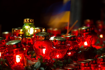 Red candles at night near the holodomor memorial. Honoring the memory of victims of famines in Ukraine. Golodomor