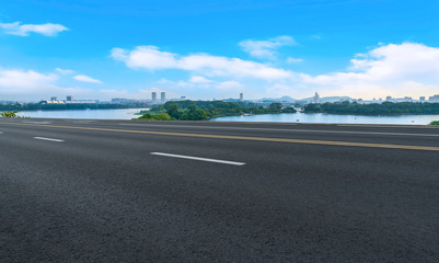 Fototapeta premium Empty asphalt road square and natural landscape under the blue sky