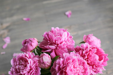 Flowers composition.  Pink peony flowers on wooden background. Mothers day. Flat lay, top view.