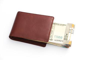 Close up view of wallet with brand new indian 50, 100, 200, 500 rupees banknotes on white background.