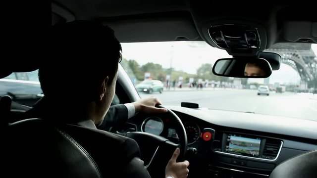Personal driver drives a car in the central part of Paris, view from interior