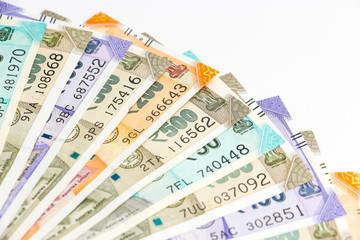Close up view of brand new indian 50, 100, 200, 500 rupees banknotes. Colorful money ornamental background.