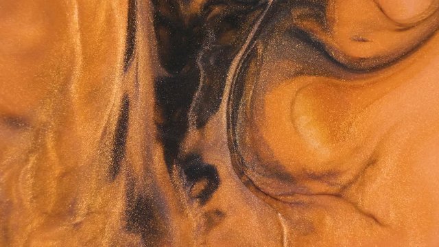 Colorful golden sand organically moves in colorful liquid