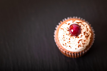 Confection Dessert Homemade Black forest cupcake on a black slate stone plate with copy space
