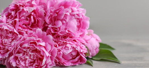 Flowers composition.  Pink peony flowers on wooden background. Mothers day. Flat lay, top view.