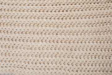 beige knitted texture, top view.