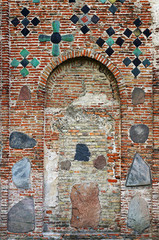 Ancient brick wall of The Kalozha church in Grodno, Belarus. Facade is decorated with majolica tiles and stones.