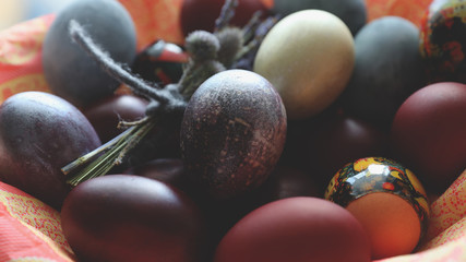 Close-up of colored painted eggs for Easter in a basket