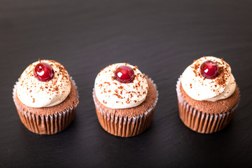 Confection Dessert Homemade Black forest cupcake on a black slate stone plate with copy space