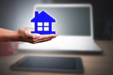 hands with home and computer, real estate online