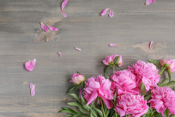Flowers composition.  Pink peony flowers on wooden background. Mothers day. Flat lay, top view.