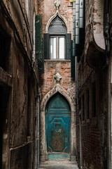 narrow street in venice italy and green door