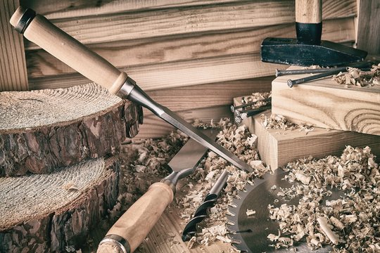 Shaving plane wooden shavings hammer flat chisels construction concept.