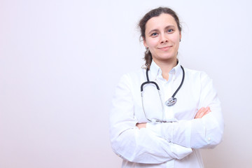 Fototapeta premium Woman doctor with stethoscope in white medical gown.