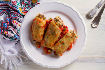 Stuffed cabbage leaves with meat, rice and vegetables. Chou farci, dolma, sarma, sarmale, golubtsy or golabki - popular dish in many countries. View from above, top studio shot