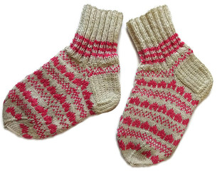 Hand knitted handmade warm winter wool woolen sock accessory with pink pattern isolated on the white background 