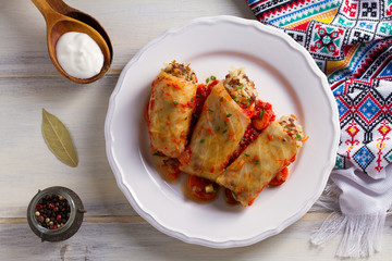 Stuffed cabbage leaves with meat, rice and vegetables. Chou farci, dolma, sarma, sarmale, golubtsy or golabki - popular dish in many countries. View from above, top studio shot