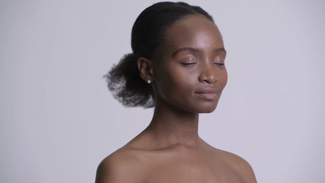 Face of happy young beautiful African woman shirtless as beauty concept