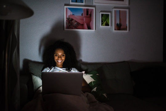 Woman In Pajamas With A Computer