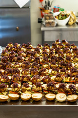 Closeup View of Sliced Bread Spread on the Table with Ingredients on them for Small Burgers