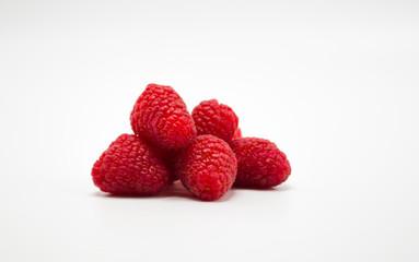small bunch of ripe red raspberries isolated on white