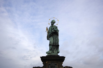 Fototapeta na wymiar Statue of St. John Nepomuk on Charles bridge, Prague, Czech Republic