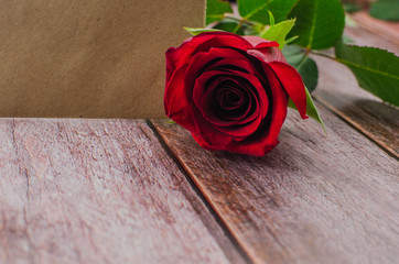Red rose and Valentines day hearts on wood. Top view with copy space